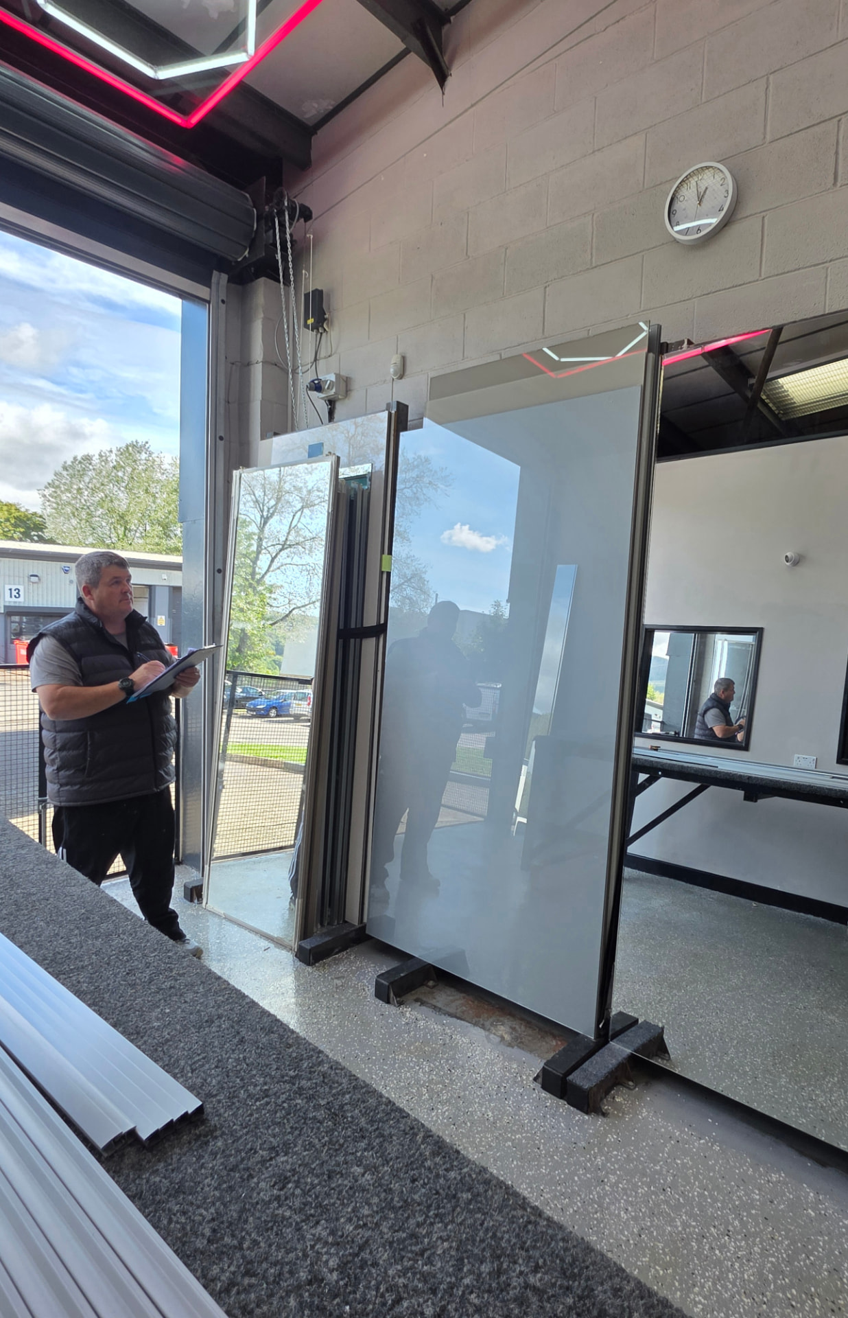 Geraint with his clipboard checking mirror panels in the SP Mirror Wardrobes workshop