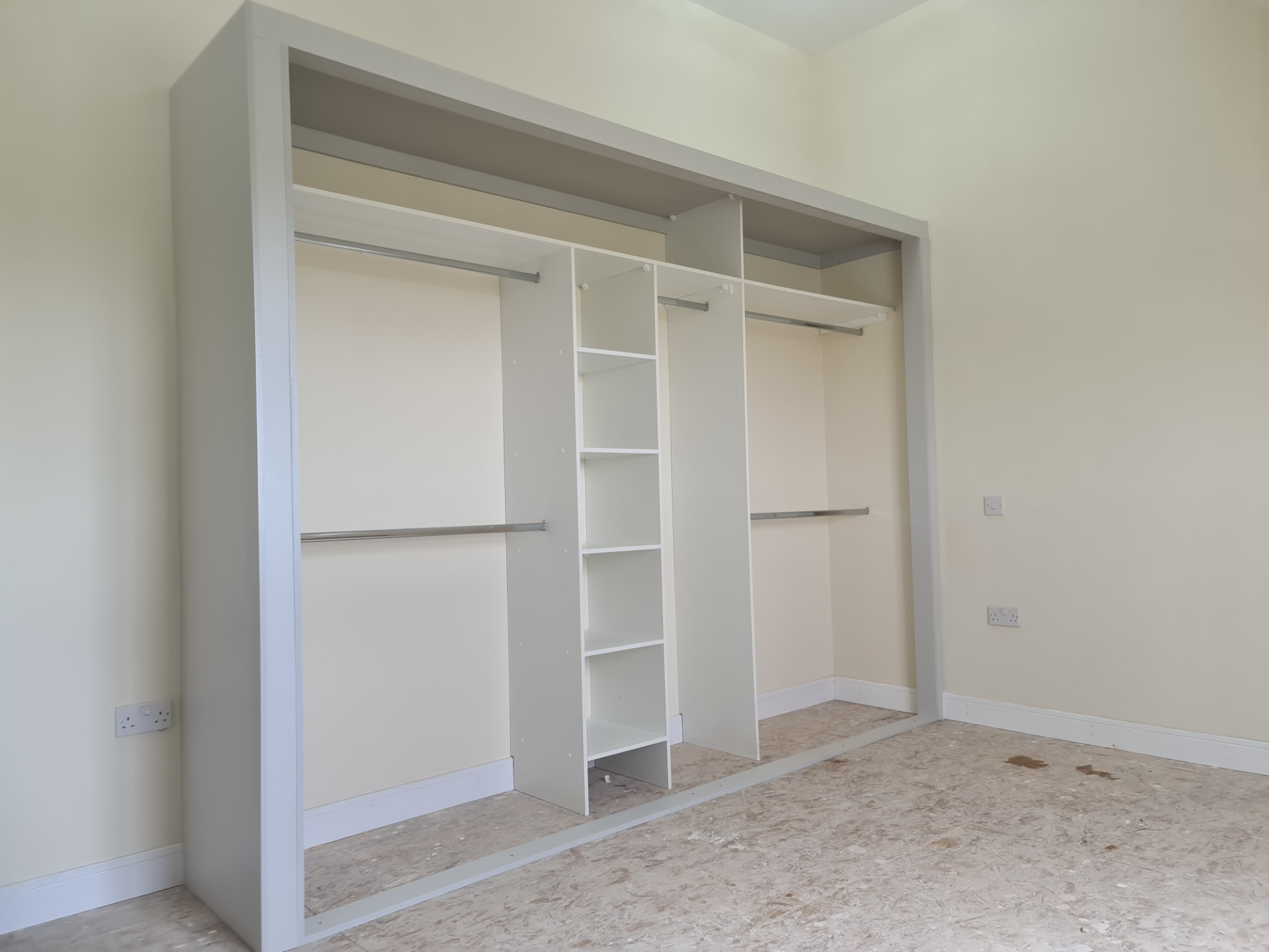 Light interior with hanging rails and open shelves in Treforest