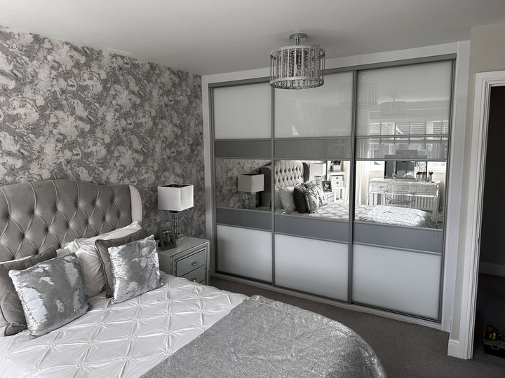 White and grey coloured glass sliding doors with a central mirror band in Tonyrefail