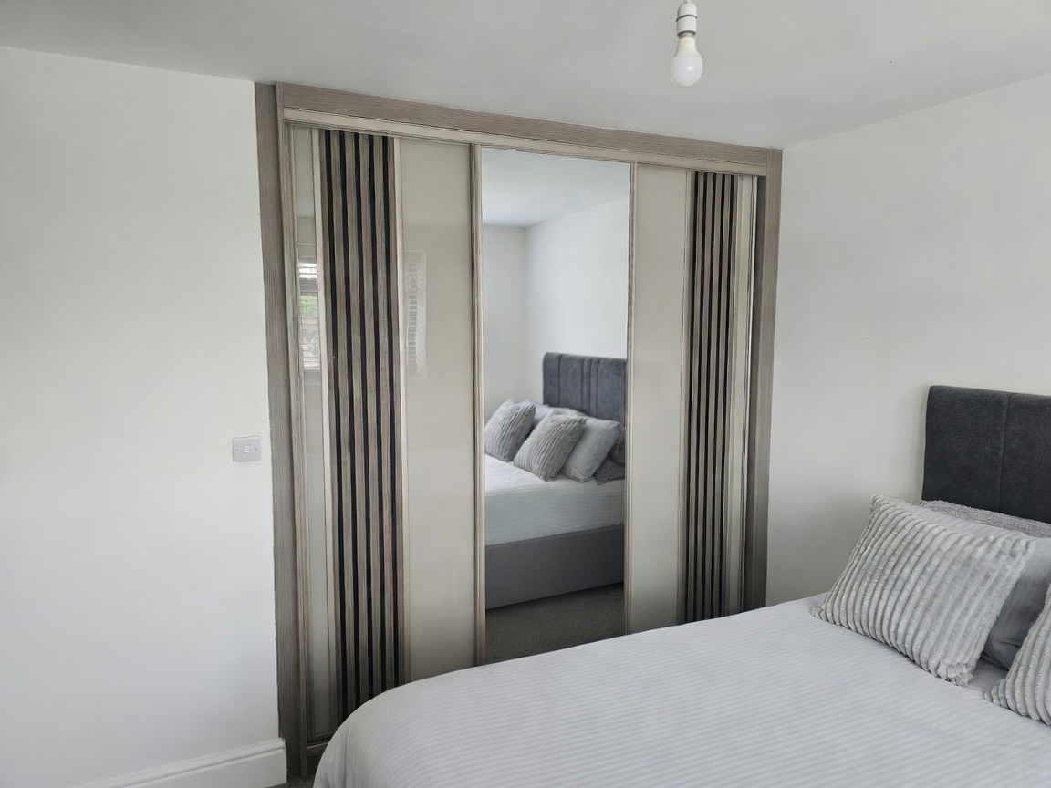 Acoustic-style panel doors with a central mirror in Swansea