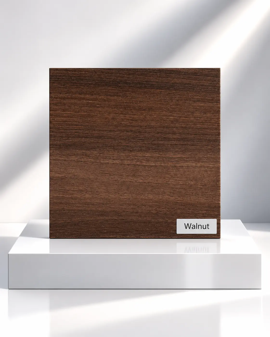 Walnut wood-effect wardrobe panel sample with horizontal grain on a white plinth