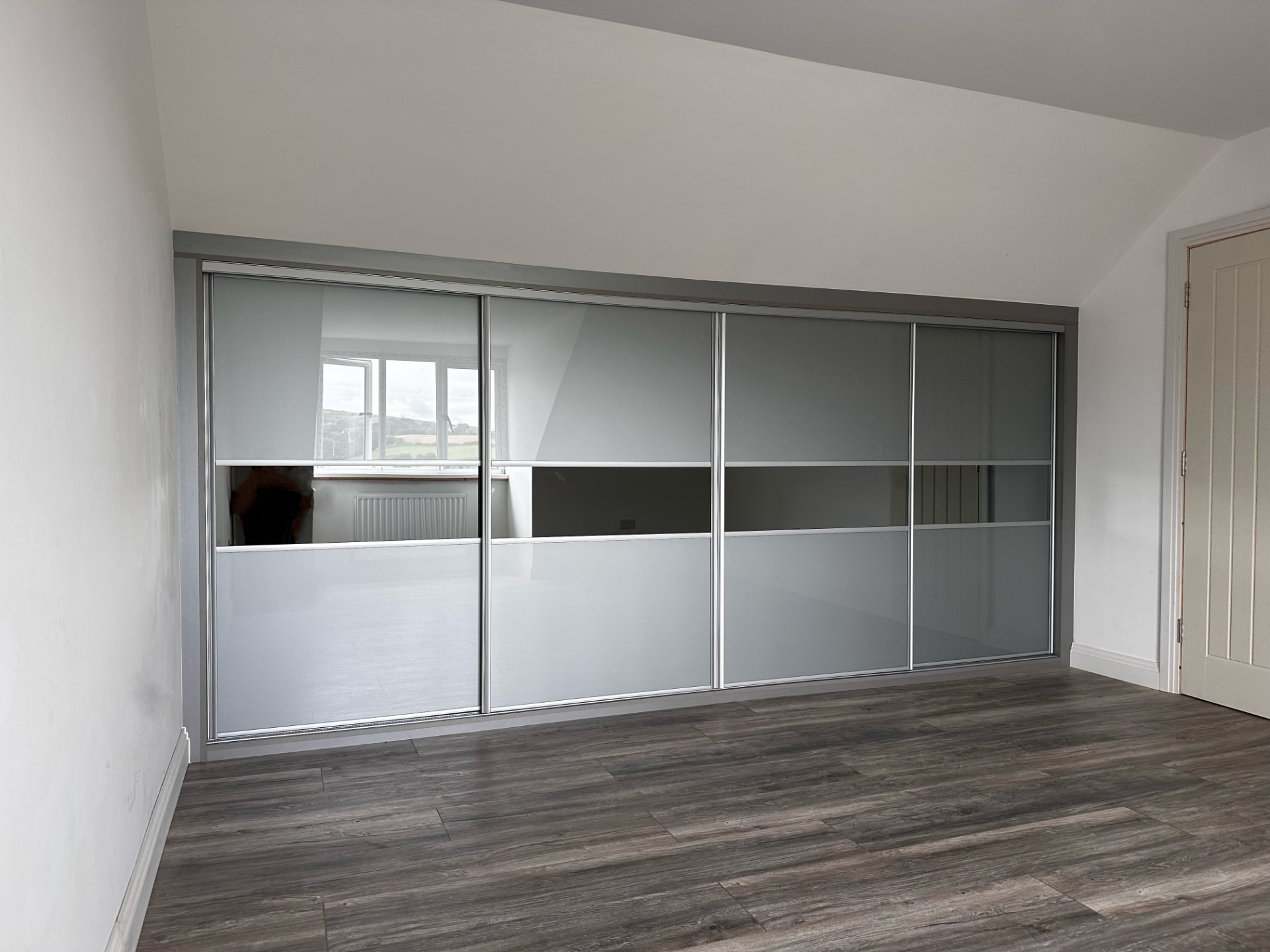Metal grey glass with a central tinted mirror panel in Merthyr Tydfil