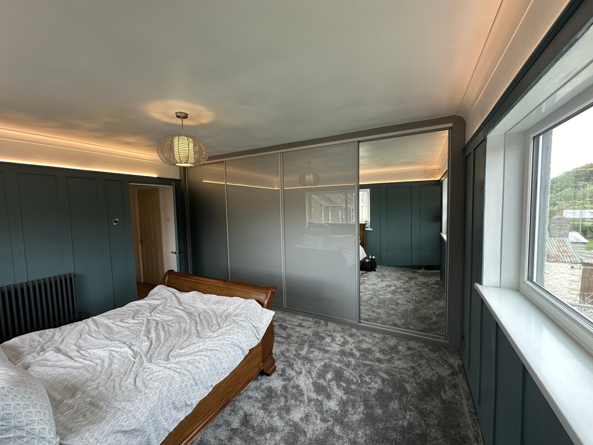 Grey-framed sliding doors combining grey coloured glass panels and a full-height mirror door in Swansea