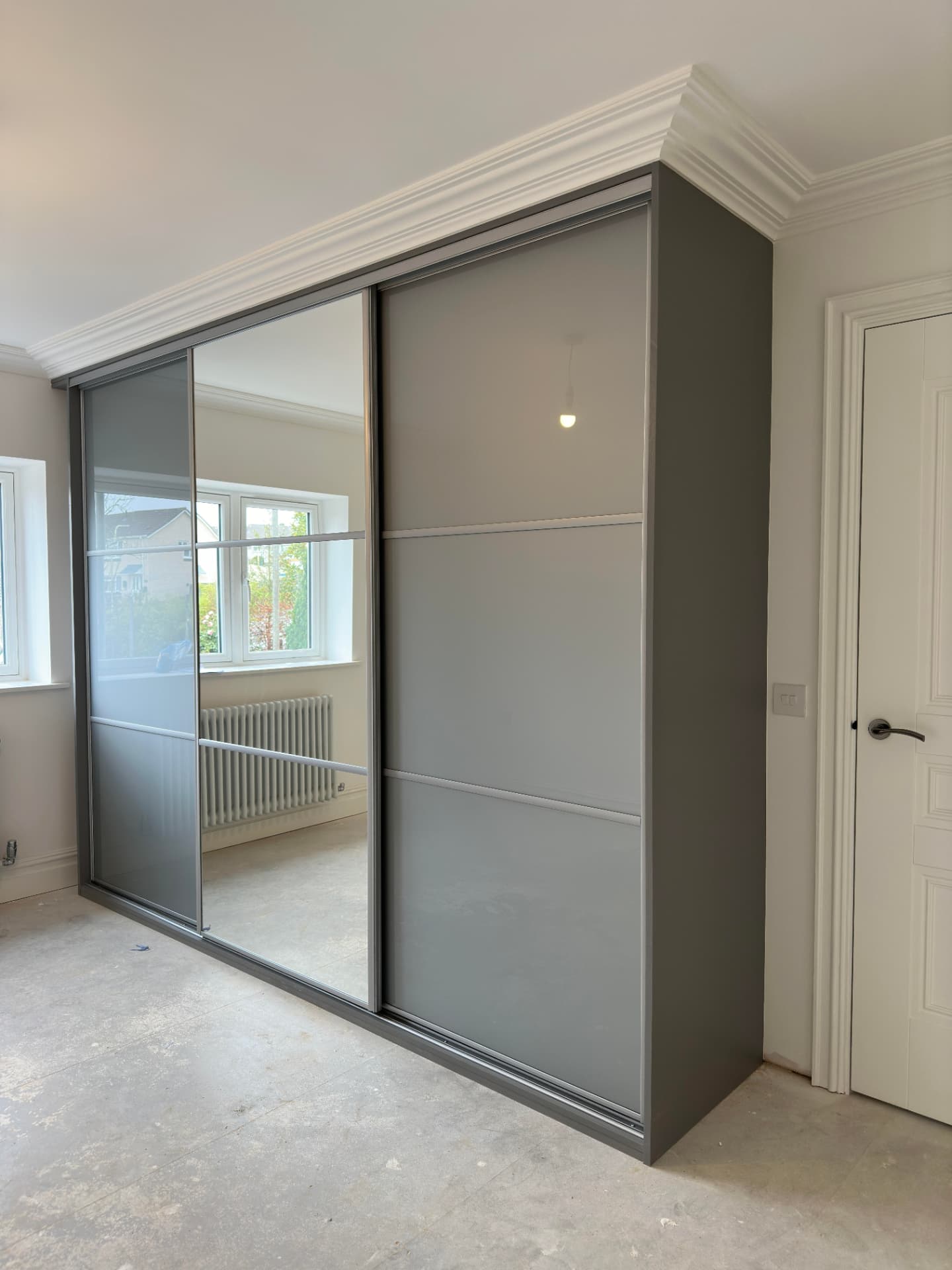 Grey panels with a central mirror section in Beddau
